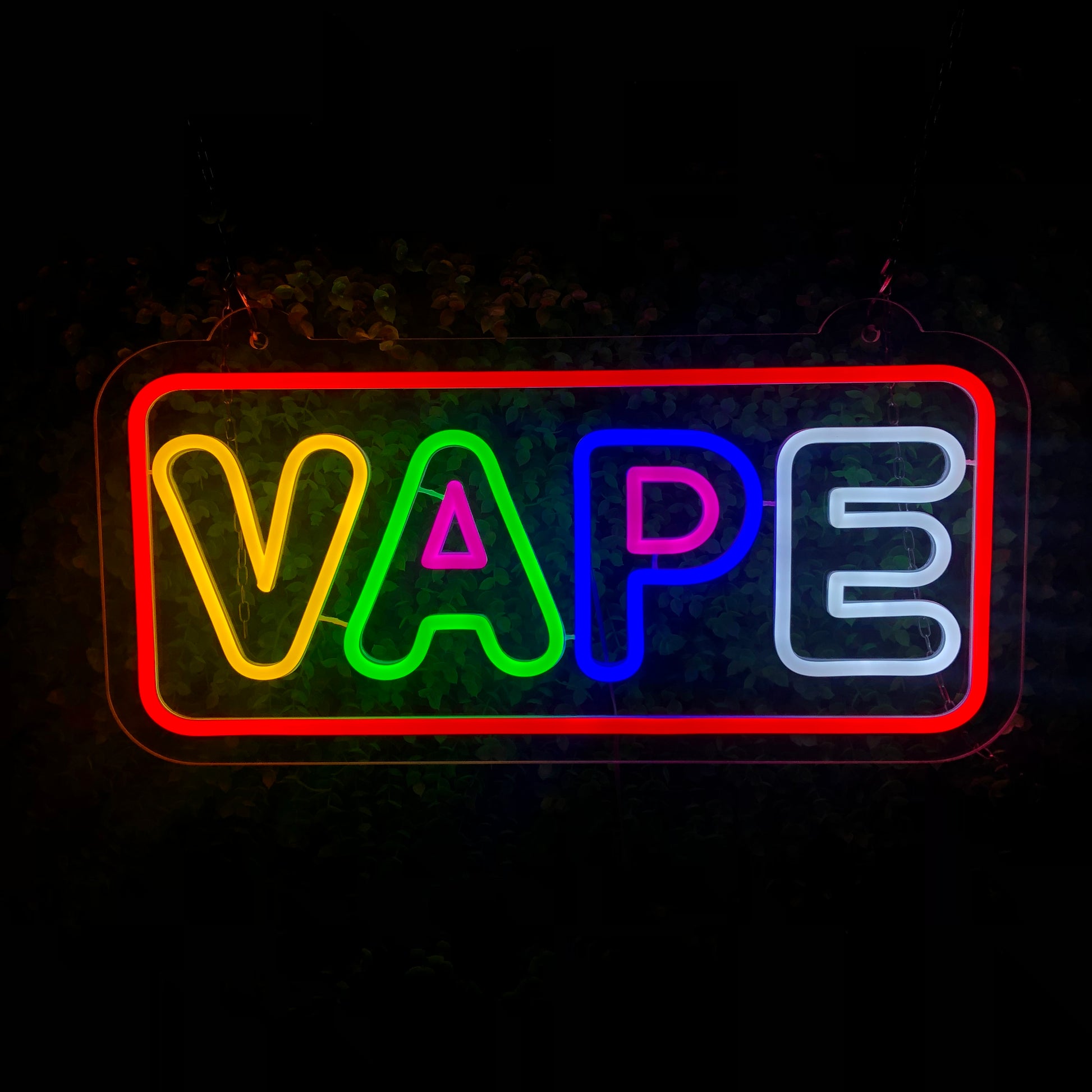 LED VAPE neon sign hanging in a vape shop window with customers in the background.